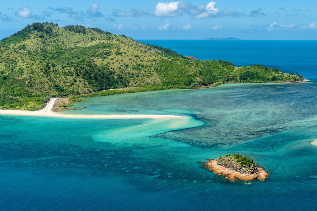 Aerial photograph showing Cockermouth Island surrounded by fringing coral reef. 