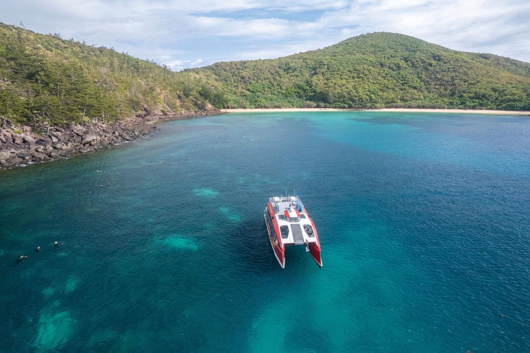 A commercial marine tourism operator anchored at Brampton Island whilst tourists are snorkelling in the water.