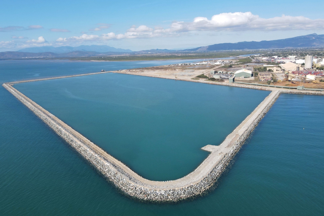 The photo shows a sea wall built to reclaim land at the port of Townsville. The wall still contains water as the reclamation is still underway. 